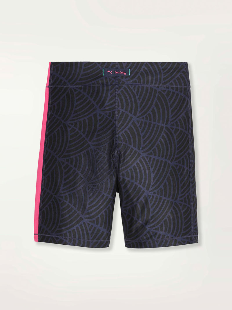 Product Shot of a Puma x lemlem bike shorts featuring hand sketched scallop print in Navy and Black colors and color block side stripes in bright pink and turquoise colors