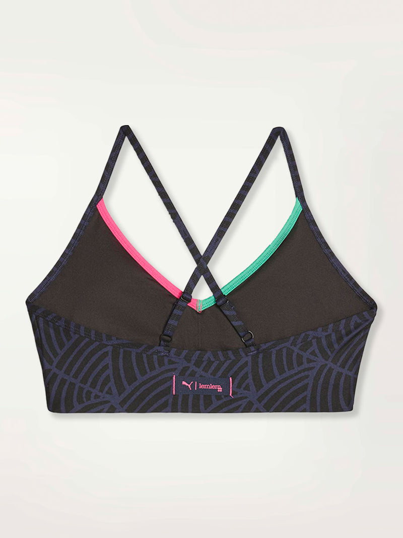 Product Back Shot of a Puma x lemlem low impact bra featuring hand sketched scallop print in Navy and Black colors and color block side stripes in bright pink and turquoise colors