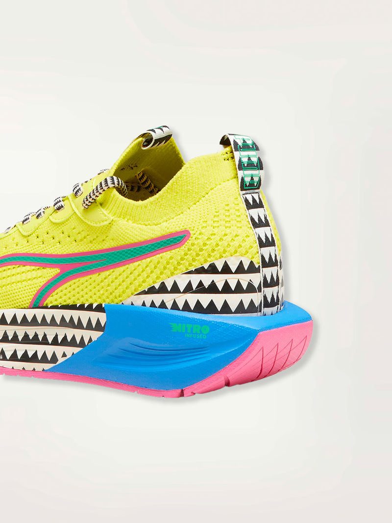 Product Side Shot of a Puma PWR XX NITRO™ Women's Training Shoe featuring a premium knitted upper highlighted with bright color details and lemlem’s traditional triangle print.