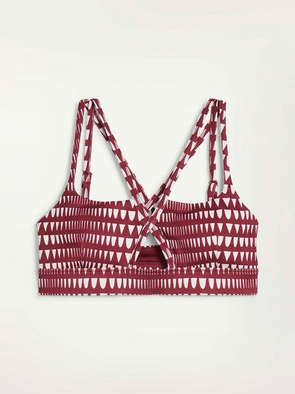 Product Front Shot of Puma x lemlem Low Impact Bra in Team Regal Red Color Featuring lemlem Triangle Pattern in White Color