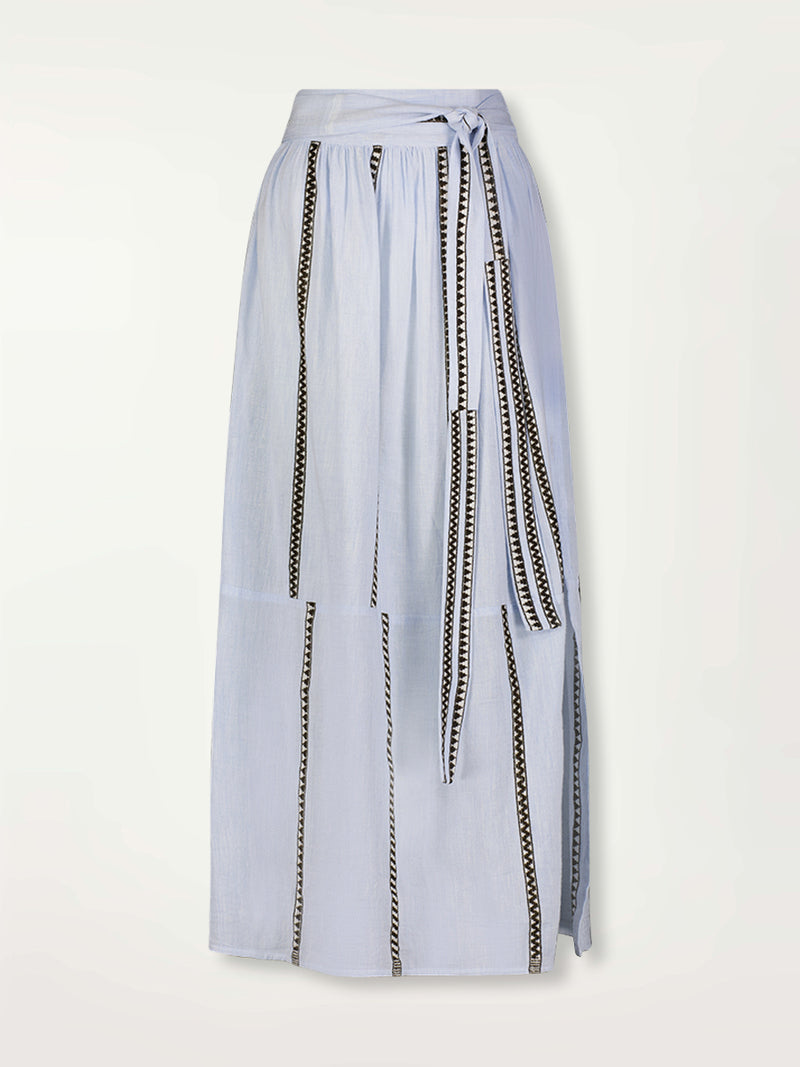 Product Front Shot of a Tola Maxi Skirt featuring  intricate bands of dark earth and ivory Tibeb patterning on a pale sky blue background.