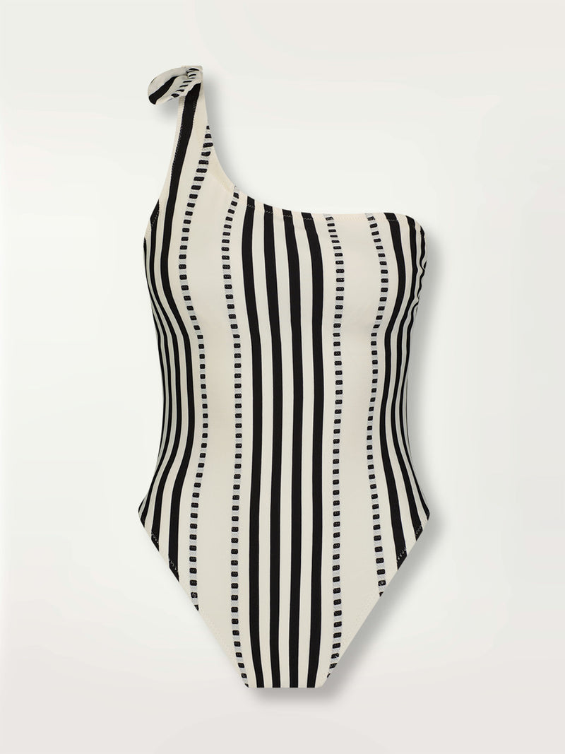 Product shot of the Eshe One Shoulder One Piece featuring architectural and textured black stripes and dotted lines on an off white background.