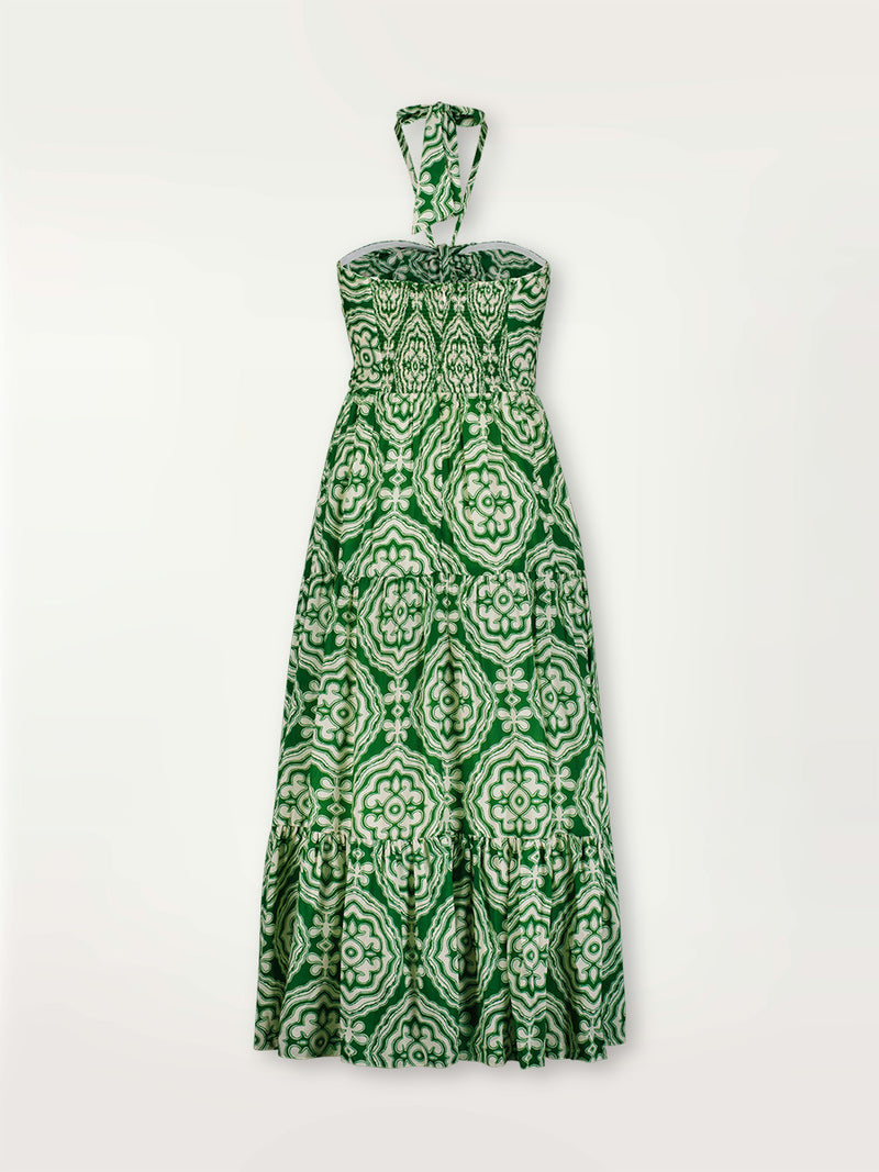 Product shot of the back of the Medallion Cutout Dress featuring architectural white patterns on a deep green background.