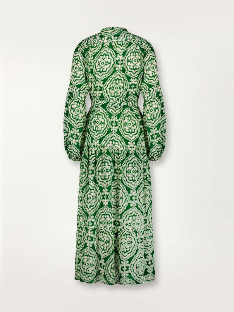 Product shot of the back the Medallion Peasant Dress featuring architectural white patterns on a deep green background.