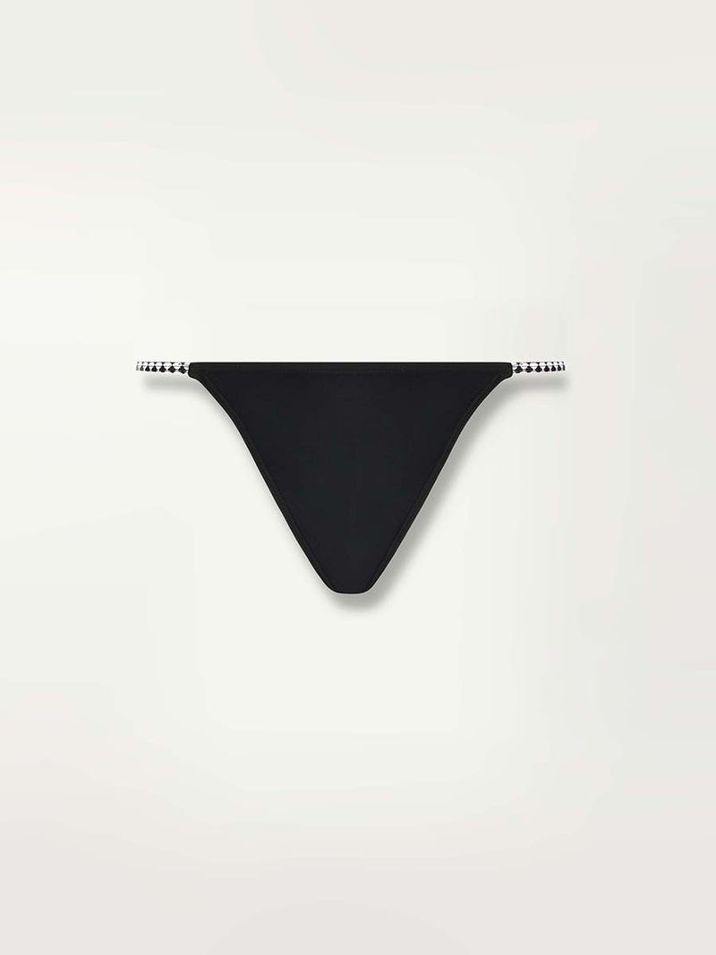 Product shot of the front of the Lena Brazilian Bikini Bottom in Black featuring a black and white tibeb waist straps.