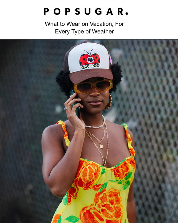 The cover of the Popsugar magazine featuring a woman on the phone wearing a colorful cap, sunglasses and dress. A very youthful and stylish aesthetic.