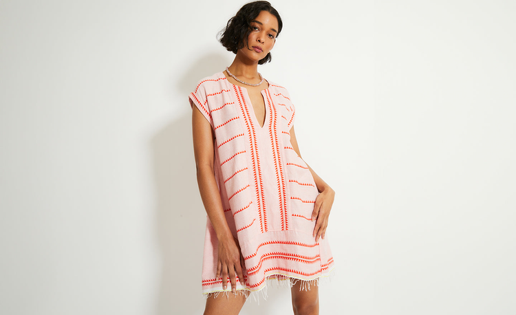 Womann Sitting on the beach in Montauk Wearing lemlem hulet vanilla caftan 