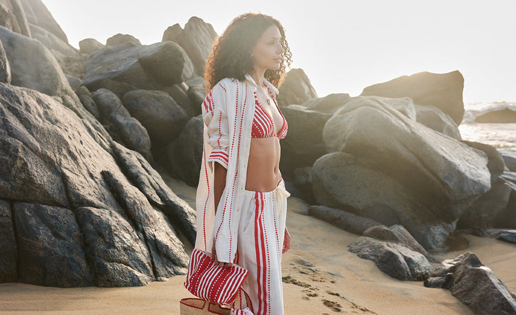 Woman in a field of pink herbs wearing the Munit pink slip dress