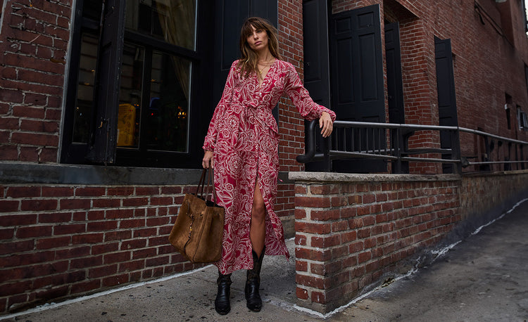 Woman standing wearing lemlem ANIKA Sundress featuring white floral pattern on red background