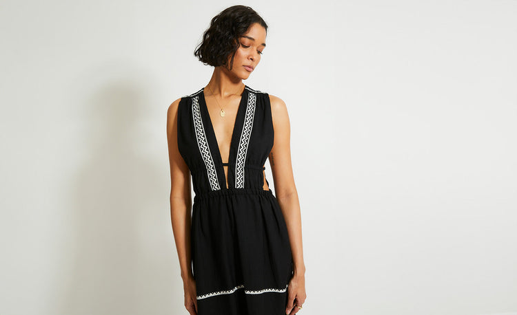 Woman Standing Wearing lemlem Lelisa Dress featuring white tibeb pattern on black background