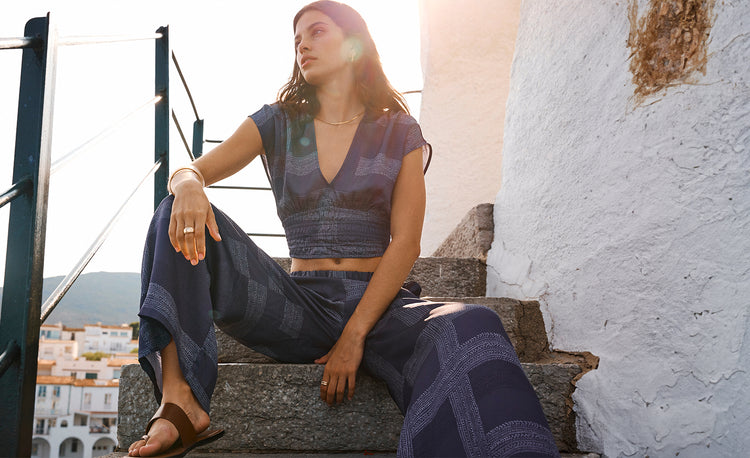 Woman Sitting on the stairs wearing Bezu Night Plunge Top and Bezu Night Desta Pants