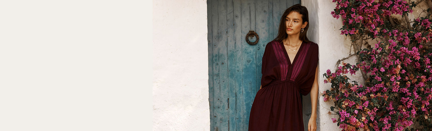 Woman Standing Wearing Jordanos Burgundy Plunge Neck dress