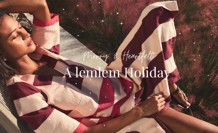 Woman lounging on a chair outside wearing a luxurious handwoven Betami Cherry dress 