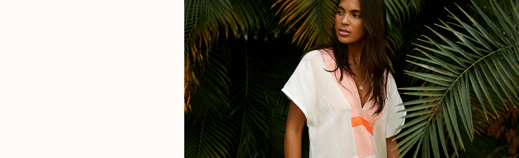 Woman Standing Wearing lemlem Ayele Blush  Gasira Caftan in Ayele Blush