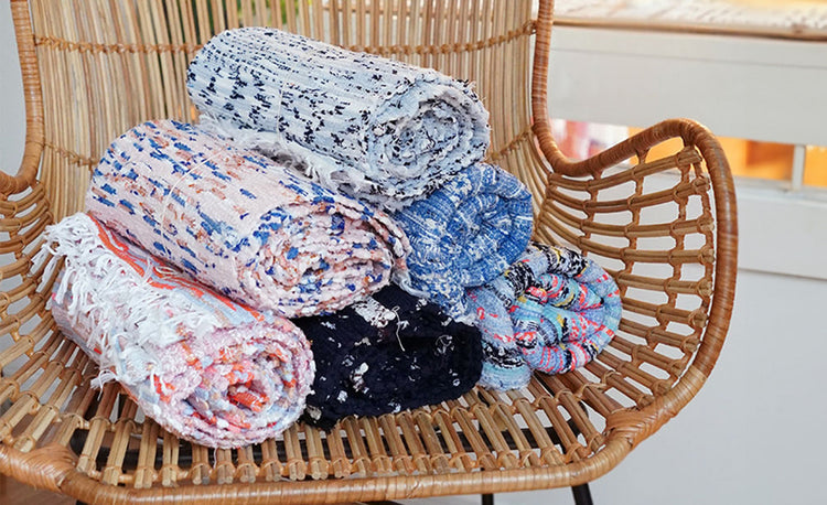 A pile of rugs on the straw chair