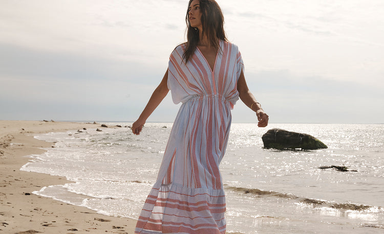 Woman Walking on the beach wearing lemlem tiki skypop plunge dress