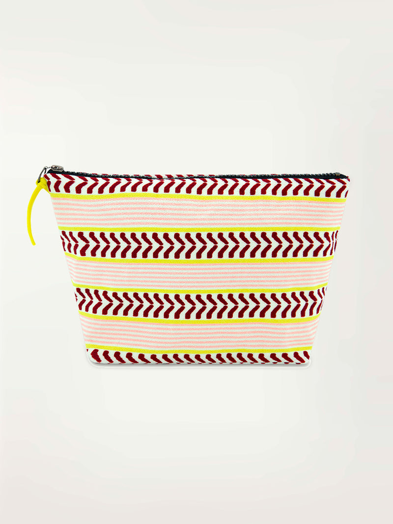 Product Front Shot of the Cora Beach Pouch featuring delicate pink stripes with a bold chevron patterned ribbon, along with muted hues of pink, burgundy, and a bright citrus hue.