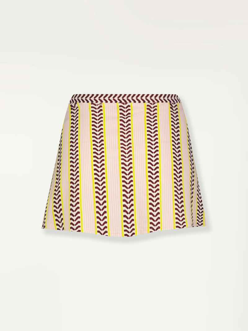 Product Back Shot of a Zera Skirt featuring delicate pink stripes with a bold chevron patterned ribbon, along with muted hues of pink, burgundy, and a bright citrus hue.