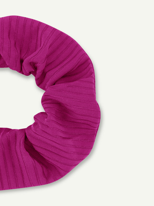 Product Close up on lemlem scrunchie featuring rich bright magenta color