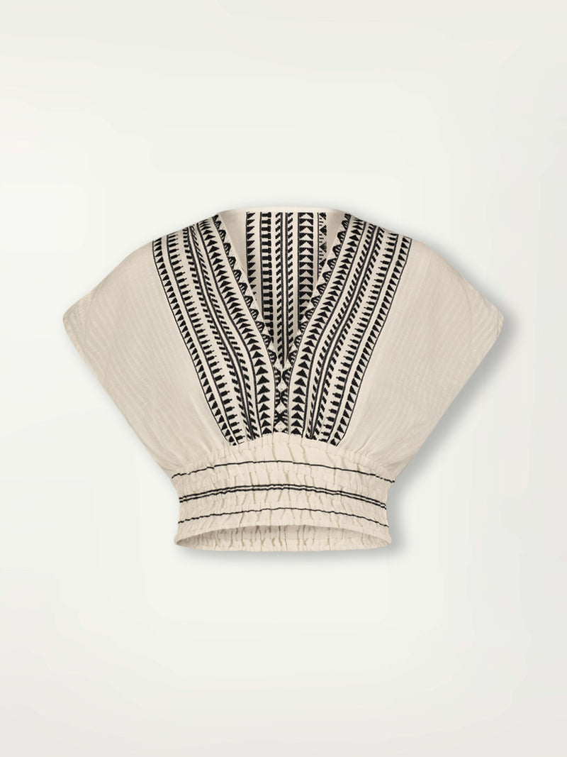 Product Front Shot of Alia Plunge Top featuring intricate black Tibeb bands on a textured vanilla background.