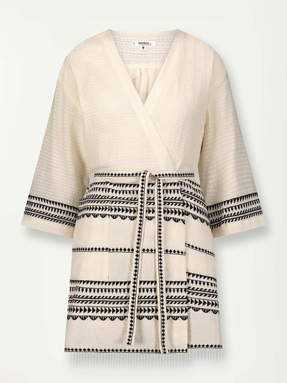 Product Front Shot of Imani Short Robe featuring intricate black Tibeb bands on a textured vanilla background.