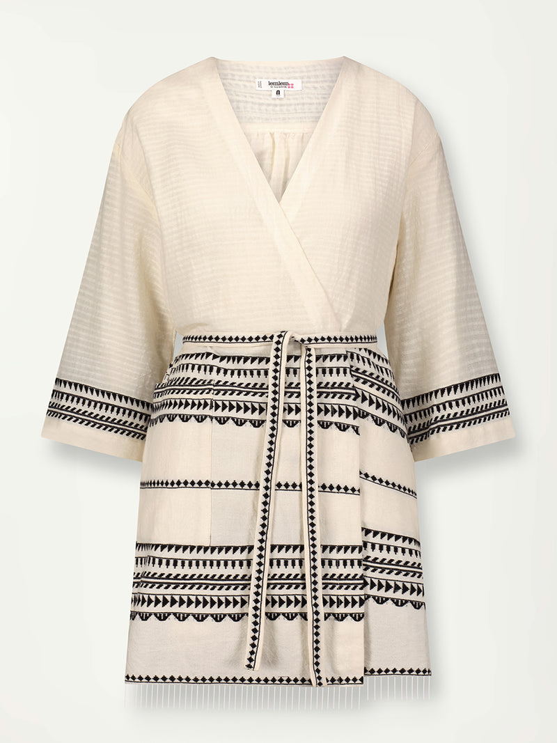 Product Front Shot of Imani Short Robe featuring intricate black Tibeb bands on a textured vanilla background.