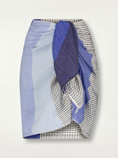 Product Front Shot of the Lema Sarong Featuring textural dot pattern that contrasts the asymmetrical color-blocking of denim blues.