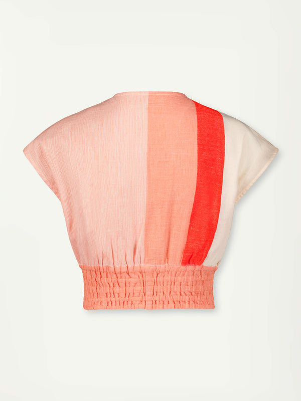 Product Back Shot of Alia Plunge Top Featuring asymmetric color block details in tan and blush colors highlighted with bright orange on the soft cream background.