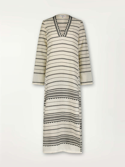 Product Front Shot of Theodora Column Dress featuring intricate black Tibeb bands on a textured vanilla background.