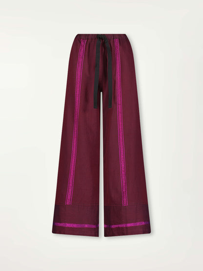Product Front Shot of Desta Wide Leg Pants featuring rich, luxurious burgundy tones with hints of magenta.