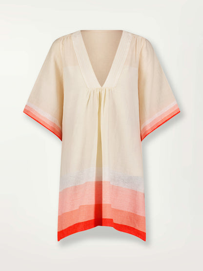 Product Front Shot of Belkis V Neck Caftan Featuring asymmetric color block details in tan and blush colors highlighted with bright orange on the soft cream background.