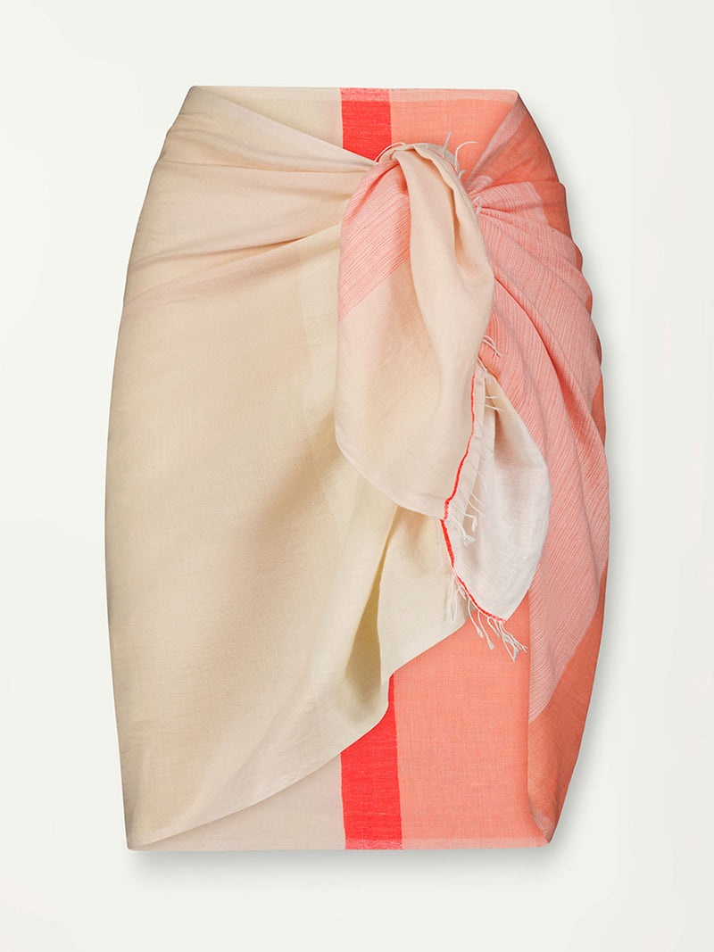 Product Front Shot of Lema Sarong Featuring asymmetric color block details in tan and blush colors highlighted with bright orange on the soft cream background.