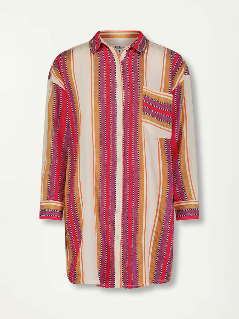 Product Front Shot of a Miriam Oversized Shirt Featuring Chest Pocket, stripe pattern in magenta, ochre, and berry tones, delineated by black and white dots and accented with a splash of neon orange on natural cotton background