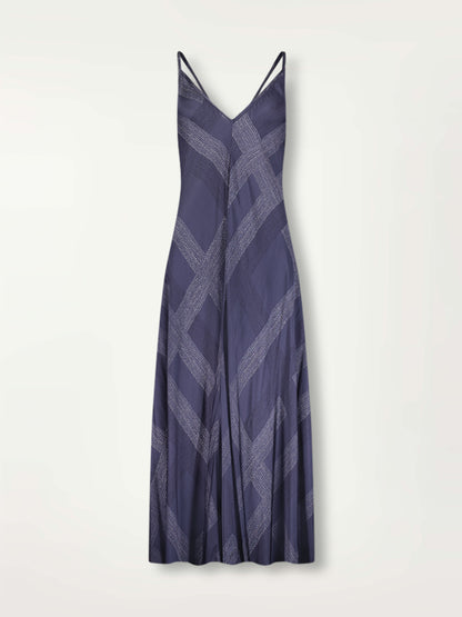 Product Front Shot of Aluna Slip Dress featuring an elegant hand-sketched chevron pattern, featuring alternating neutral and charcoal stripes set against a cool steel blue background. 