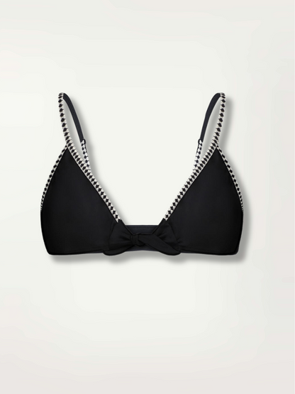 Product shot of the front of the Lena Tie Front Bikini top in Black featuring a black and white tibeb trim and neck and back ties.