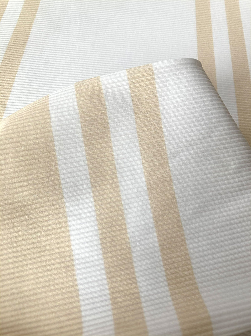 Close Up on Ayele Cappuccino Ribbed Fabric featuring bold stripe pattern in subtle neutral tan color on classic white ribbed ground