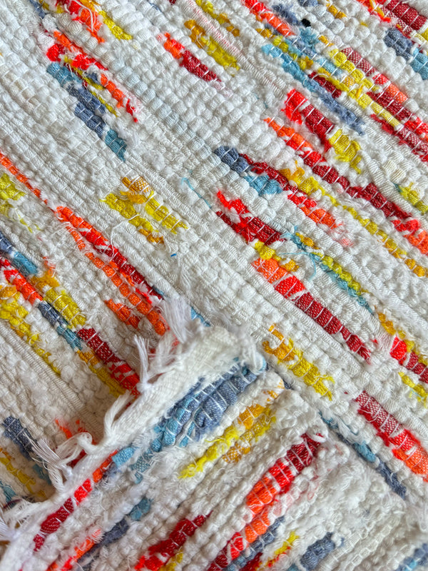 Product shot of lemlem upcycled handwoven MESFIN Rug with multicolored patterns