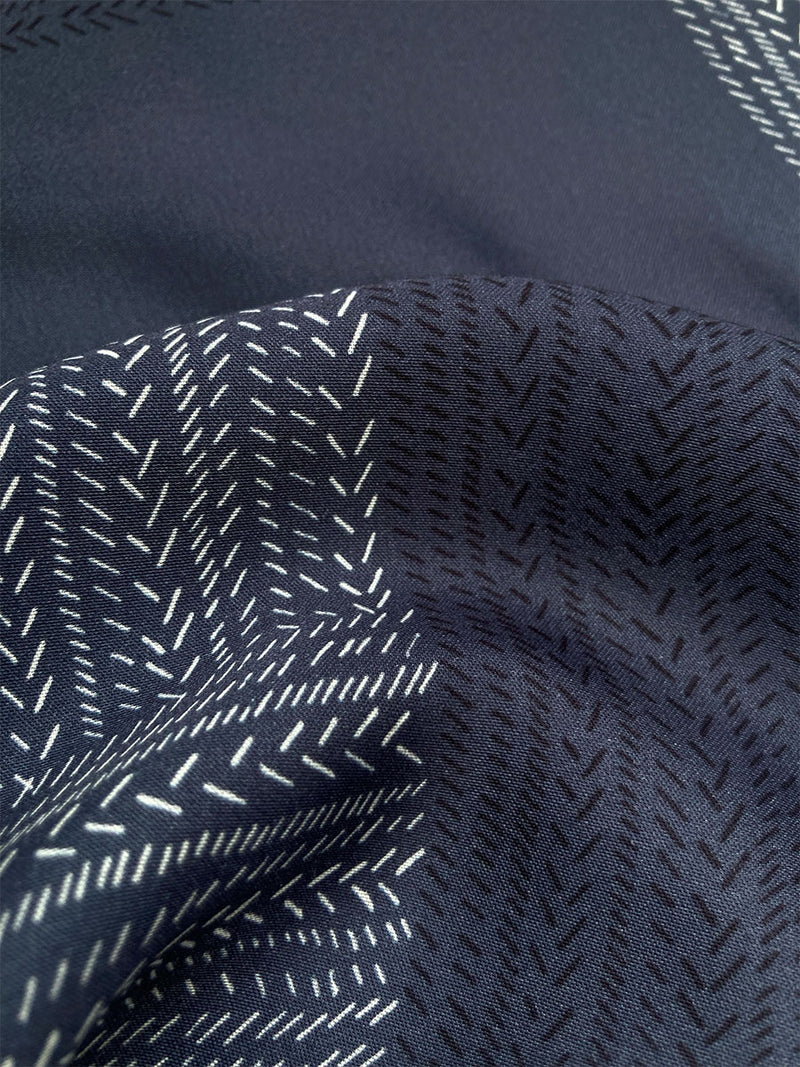 Close up on Bezu Night Fabric featuring alternating neutral and charcoal stripes set against a cool steel blue background