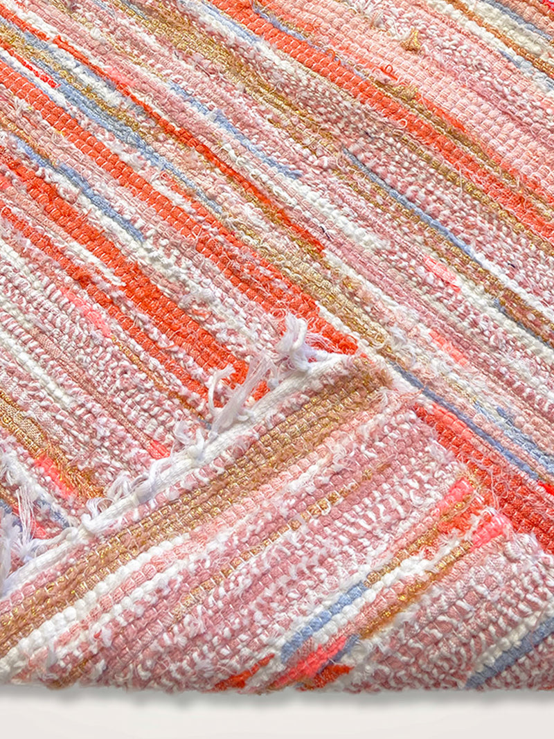 Close up Shot of Coral Rug Featuring Coral Color Stripes and Blue Stripes