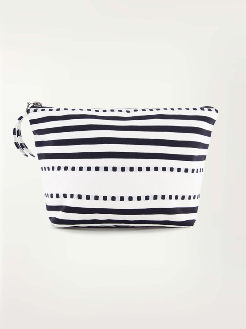 Product picture of a white travel pouch featuring horizontal solid and doted black stripes and a black zip closure at the top.