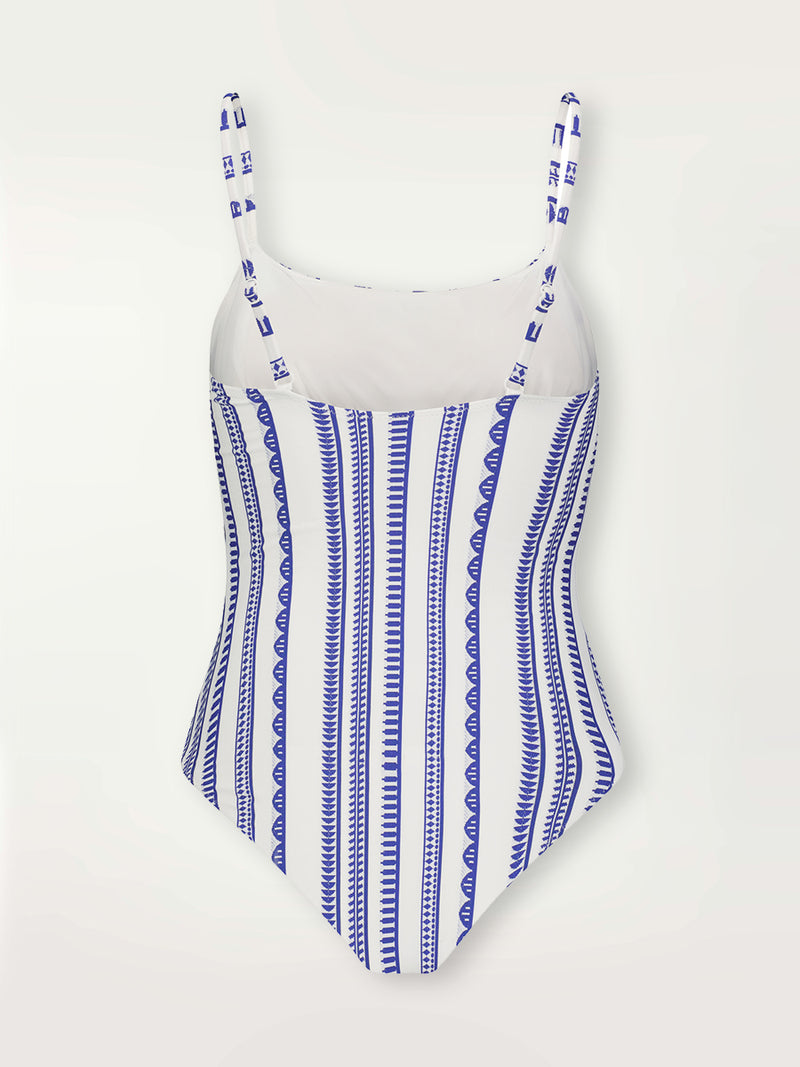 Product shot of the back the Yani Classic One Piece featuring blue tibeb diamond design bands on a textured seersucker white background.  