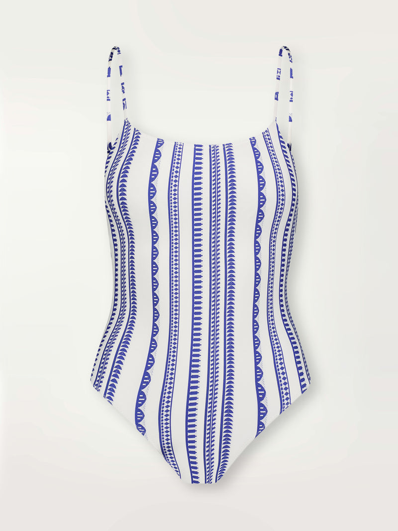 Product shot of the Yani Classic One Piece featuring blue tibeb diamond design bands on a textured seersucker white background.  