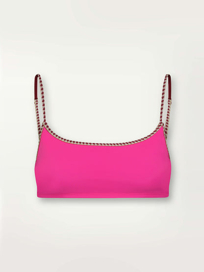 Product shot of the Lena Bralette Top in bright neon pink with a bordeaux diamond trim.
