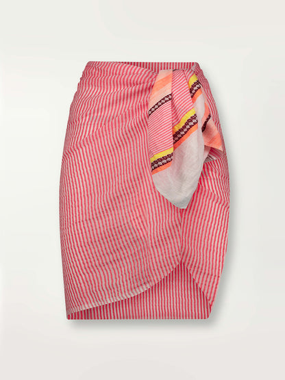 Product shot of the Cirq Sarong featuring pink, orange and yellow stripes and signature Tibeb design in burgundy bands.
