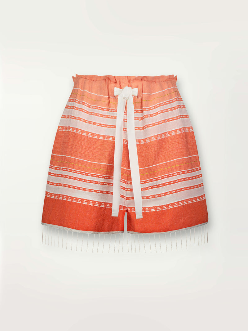 Product shot of the Eshal Shorts featuring white doted stripes with gradiant orange and tangerine bands on a lilac and white background.