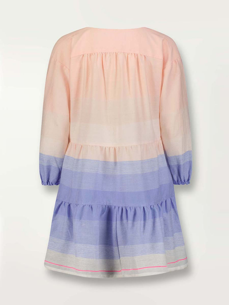 Product shot of the back the Jelba Popover Dress featuring gradient color block design of nine shades of soft pink and blues highlighted by a bright pink mini stripe at the edge of the dress.