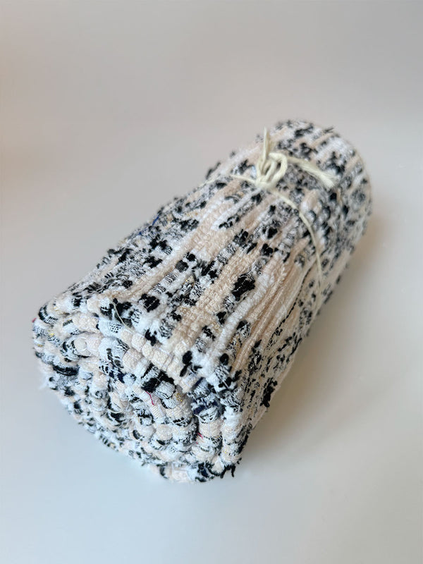 Product shot of lemlem upcycled handwoven MESFIN Rug with multicolored patterns