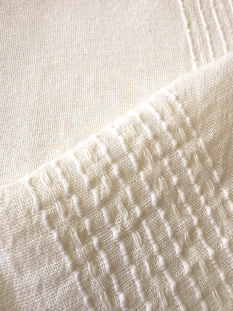 Close up on lemlem handwoven Lacee Cream fabric featuring cream color