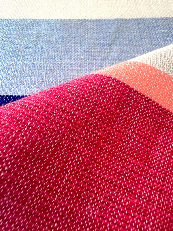 Close-up of fabric with red pattern on a multicolored background