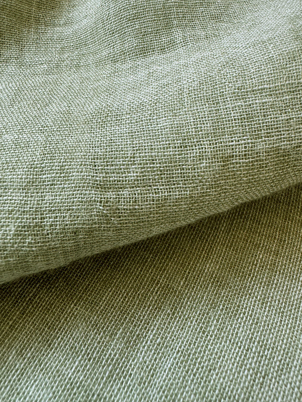close up on lemlem Nefas gauze fabric in a delicate earthy sage color